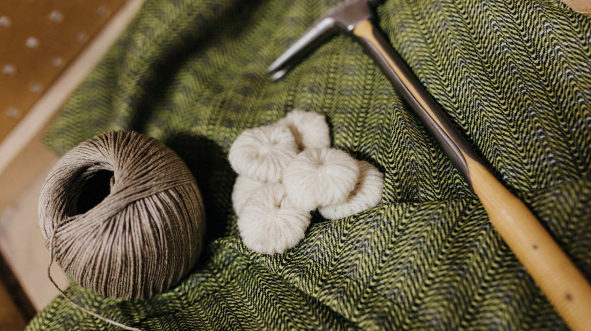 Image of tweed fabric and upholstery tools