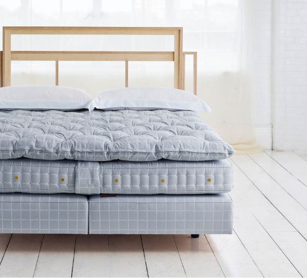 Savoir bed featuring the no2 base, the mattress, the topper and cushions with our naked headboard