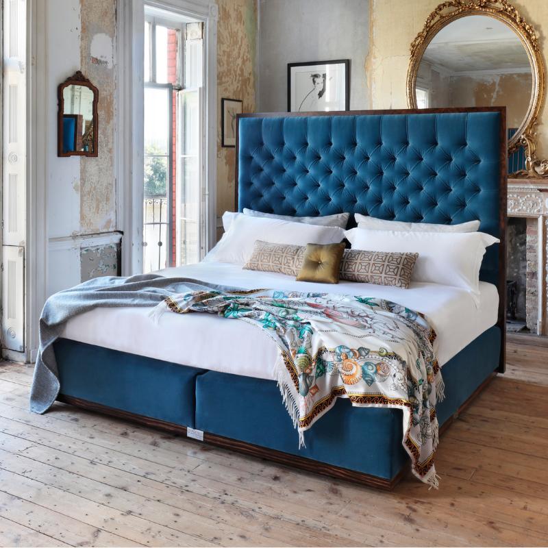 Our State bed with an upholstered blue headboard and base
