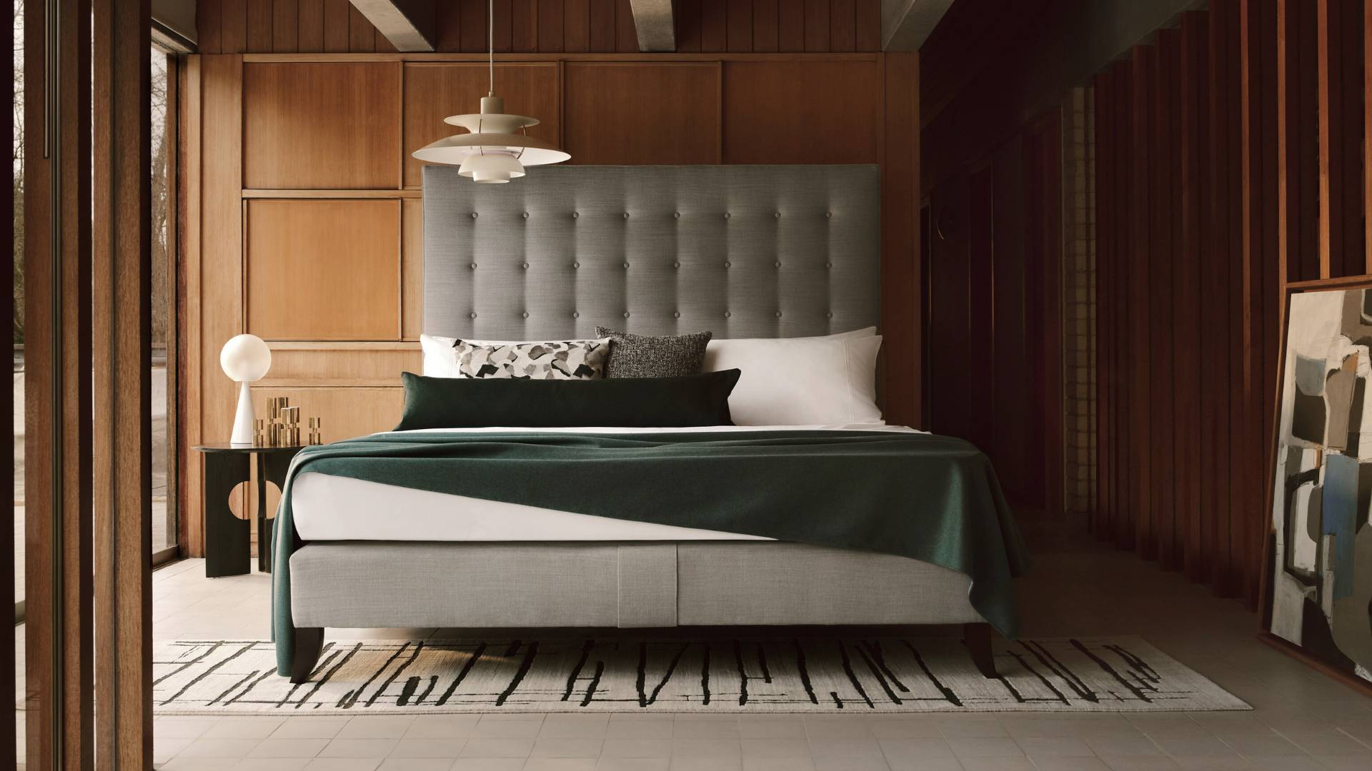 Our Holly bed with a fully upholstered blue headboard and base